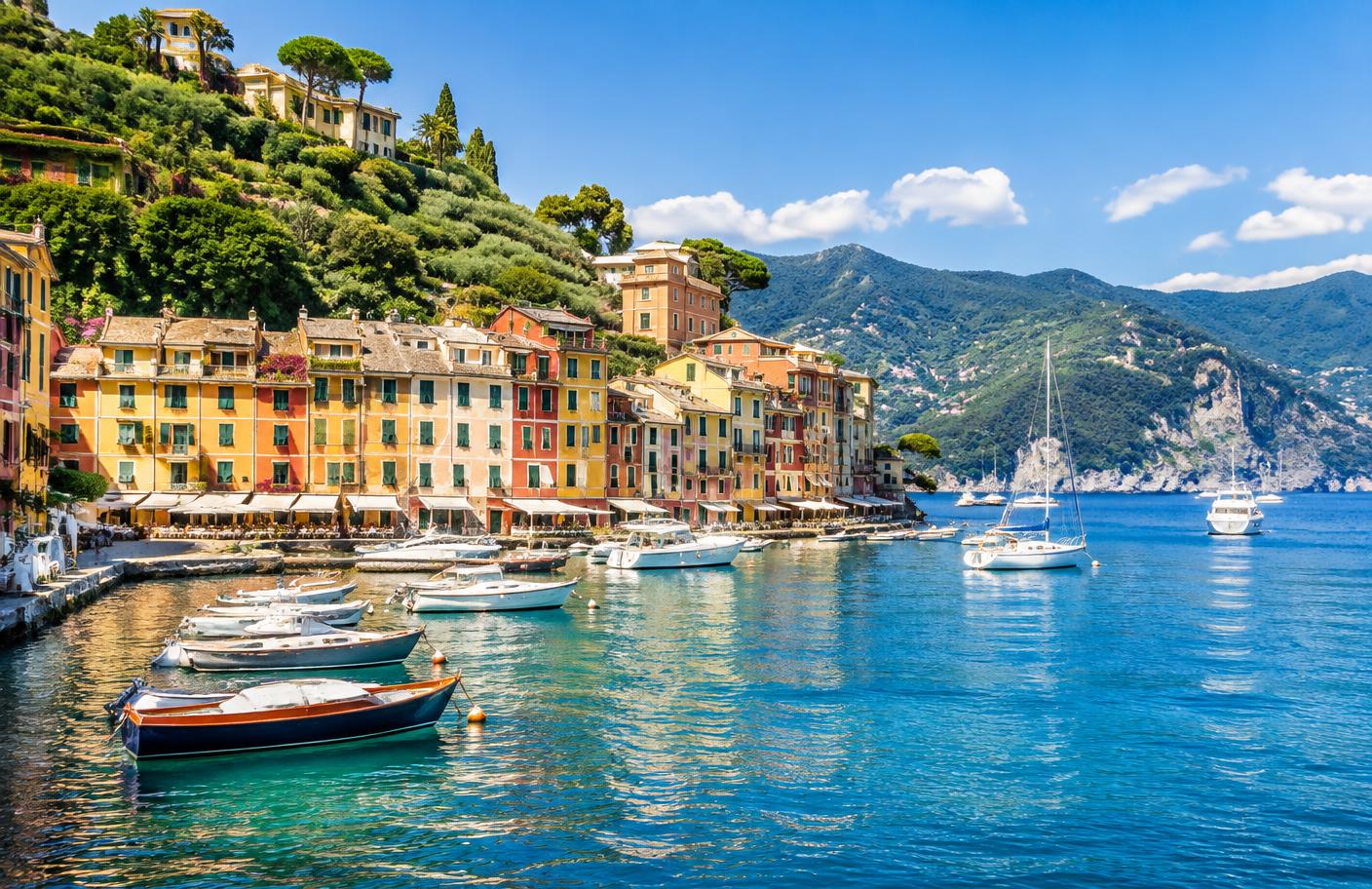 Colourful Mediterranean harbour buildings beside clear blue water